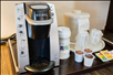 Coffee maker and complimentary coffee and tea supplies.