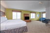 One king bed, a flat-screen TV and a seating area inside a guest room.