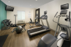 Fitness facility with cardio equipment and free weights.