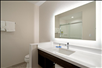 Enjoy the convenience of a well-lit vanity inside a private bathroom.