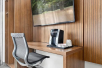 Work desk and ergonomic desk chair, with a Keurig coffee maker.