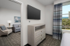 A separate living area with flat screen TV and seating area at Homewood Suites by Hilton Destin, FL. 