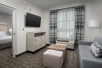 A separate living area with flat screen TV and seating area at Homewood Suites By Hilton Destin. 
