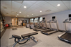 Fitness center with treadmills, elliptical trainers, and other gym equipment.