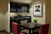 Kitchenette, dining table, microwave, stovetop, dishwasher at Homewood Suites by Hilton Toronto Vaughan, ON.