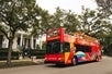 Hop-On Hop-Off City Sightseeing Bus touring down St. Charles Avenue in New Orleans.