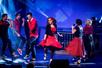 Men and women in red and black dancing and singing on stage at Hot Rods & High Heels in Branson, Missouri.