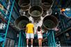 Visitors looking at the rocket engines of a space shuttle at the Kennedy Space Center.