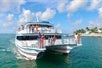Tour guests on the glass bottom boat with the shoreline in the background on the Key West Glass Bottom Boat Tour, Key West Florida.
