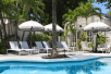 Outdoor pool with sun loungers and umbrellas at Kimpton Lighthouse Hotel, Key West FL. 