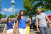 A family of four walking on a sunny day  at King's Island in Cincinnati, Ohio.
