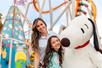 A mother and daughter posing for a photo with Snoopy at Knott's Berry Farm in Buena Park, California.