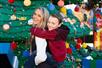 A mom and son if front of a Lego Christmas tree at LEGOLAND Florida Resort.