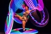 Female cirque performer with colorful hoops on stage at the Zero Gravity show presented by Le Grand Cirque.