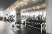 Fitness room with cardio equipment and weights.