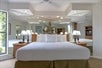 One king bed with plush beddings inside a suite.