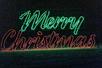 The word "Merry" made of green lights and "Christmas" made of red lights on display on the Lights of Joy Christmas Drive-Thru.