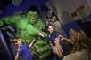 A mother taking a photo of her children posing with the Hulk at Madame Tussauds in Las Vegas, Nevada.