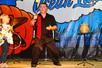 A man doing a magic trick on stage with a young girl helping at Magic Show Starring Michael Bairefoot in Myrtle Beach, South Carolina, USA.