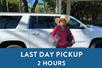 A woman in a big hat smiling in front of a white SUV and a box saying "Last Day Pickup 2 Hours" with Maui Pickup in Maui, Hawaii, USA.