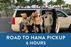 A family standing in front of a white SUV and a blue box saying "Road to Hana Pickup 6 Hours" with Maui Pickup in Maui, Hawaii, USA.