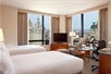 2 Double beds, city view, work desk, flat-screen TV, chair at Millennium Hotel, NY.
