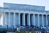 Wide shot of the Lincoln Memorial  with several group of tourists on the steps and below them on an overcast day in Washington DC.