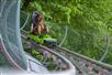 A woman on the ride comes around the corner of the Moonshine Mountain Coaster in Gatlinburg, TN