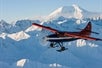 A wide view of the plane flying over Otter Mountain in Talkeetna, Alaska.