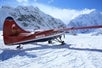The plane landing on the glacier with the mountains in the background in Talkeetna, Alaska.