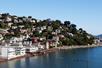 Wide shot of coast line of the city of Sausalito no a sunny day with no boasts in the water on a bright sunny day.