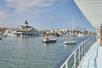 View of a marina full of boat form the deck of a cruise ship on a bright sunny day in Newport Beach, California.