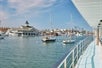 View of a marina full of boat form the deck of a cruise ship on a bright sunny day in Newport Beach, California.