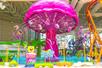 A giant pink jellyfish swing ride and SpongeBob on a jellyfish in front at Nickelodeon Universe at American Dream in Newark, New Jersey, USA.