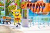 SpongeBob standing in front of a ride with Squidward in the back at Nickelodeon Universe at American Dream in Newark, New Jersey, USA.