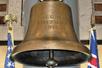 The historical USS Arizona's Bell, a large antique bronze bell with "U.S.S. ARIZONA 1916" engraved on the front and flags on both sides.