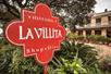 Close up of the deep red sign for the Historic La Villita with the building in the background in San Antonio.