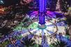 Aerial view looking down on the Orlando Starflyer while people board the swing ride at night.