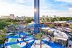 The Orlando Starflyer swing ride with no one on it but park guests at the fence in the afternoon at ICON Park.