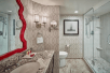 Fresh towels, bathroom amenities and glass-enclosed shower inside a private bathroom at Paris Las Vegas, NV.