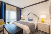 1 King bed inside a guest room at Paris Las Vegas, NV.