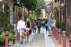 People walking through Elfreth's Alley. City Sightseeing Philadelphia, Philadelphia Pennsylvania.