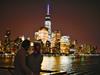 Two person enjoying the city lights at NYC Harbor Dinner Cruise by Hornblower