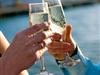 A couple enjoy a Champagne toast on the outer deck aboard the Bateaux New York Premier Dinner Cruise.