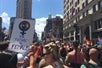 Streets crowded with a pride parade on the Pride Walking Tour in Manhattan, New York, USA.