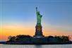 A sunset view of the Statue of Liberty on a Private Sailboat Charter to the Statue of Liberty and NYC.