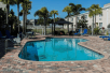 Outdoor pool with sun loungers at Quality Inn & Suites Near Fairgrounds & Ybor City.