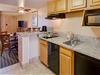 Kitchenette with Breakfast Bar & Counter Stools at  Staybridge Suites Royale Parc Suites