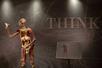 An anatomically correct human muscular model standing up with the word "THINK" on the wall behind it at REAL BODIES at Horseshoe Las Vegas.