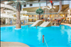 Waterslides, and kids' play area with a pirate ship in the indoor waterpark.